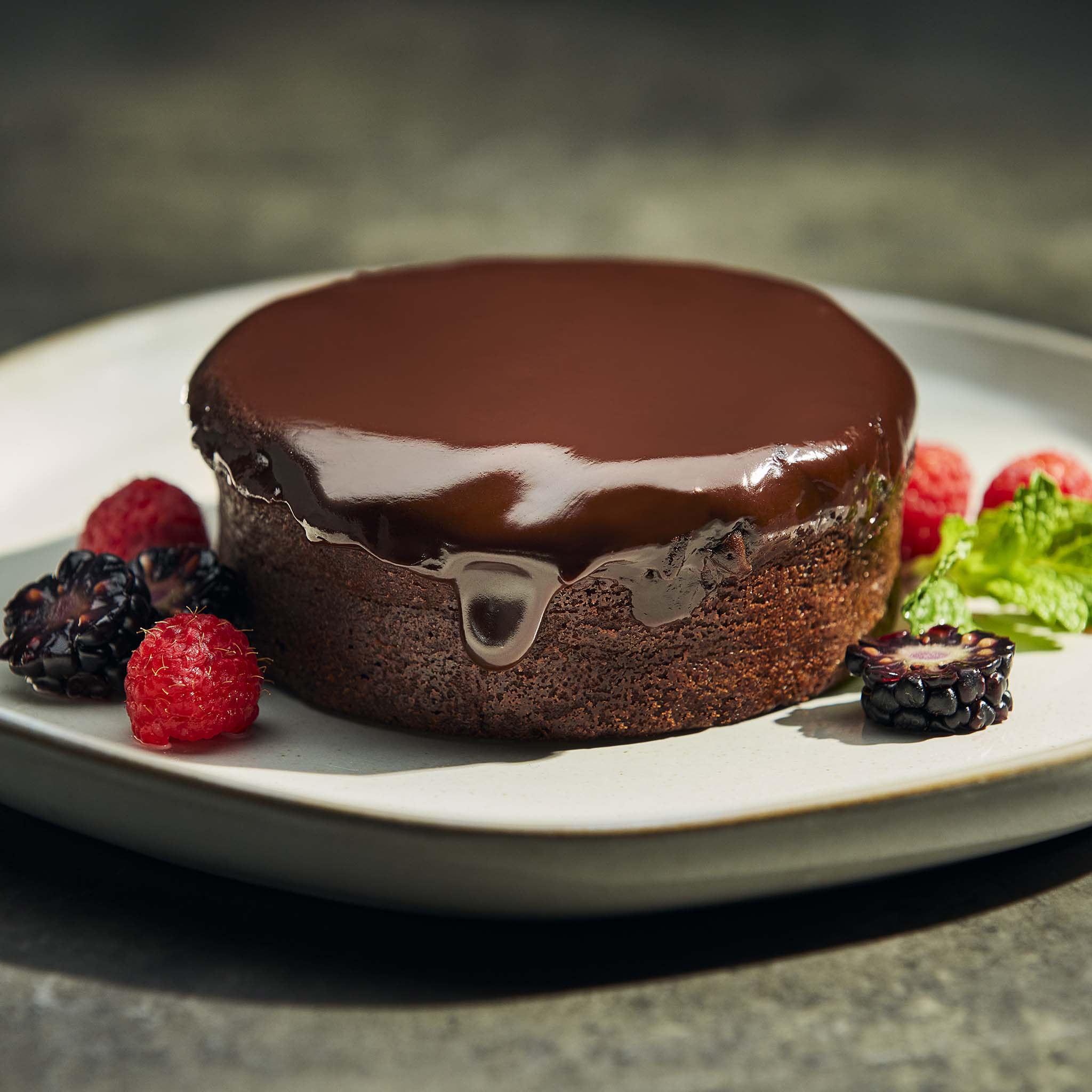 Triple chocolate brownie with berries on a plate