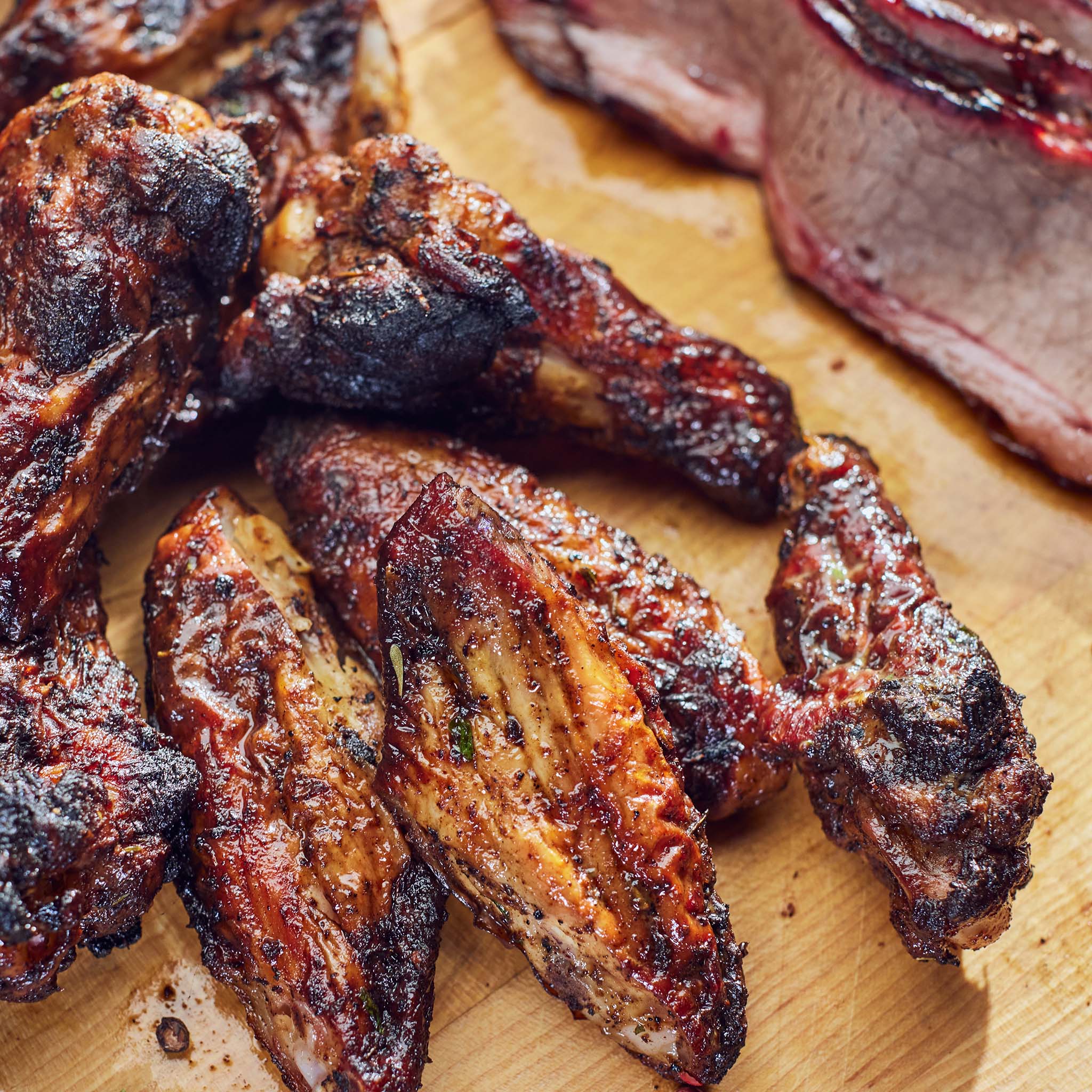 Grilled chicken wings on a wooden cutting board