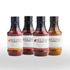 Four bottles of Jack Stack Barbecue sauce on a white background